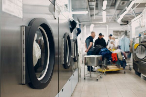 Dry cleaning clothes. Clean cloth chemical process. Laundry industrial dry-cleaning Dry cleaning clothes. Clean cloth chemical process. Laundry industrial dry-cleaning
